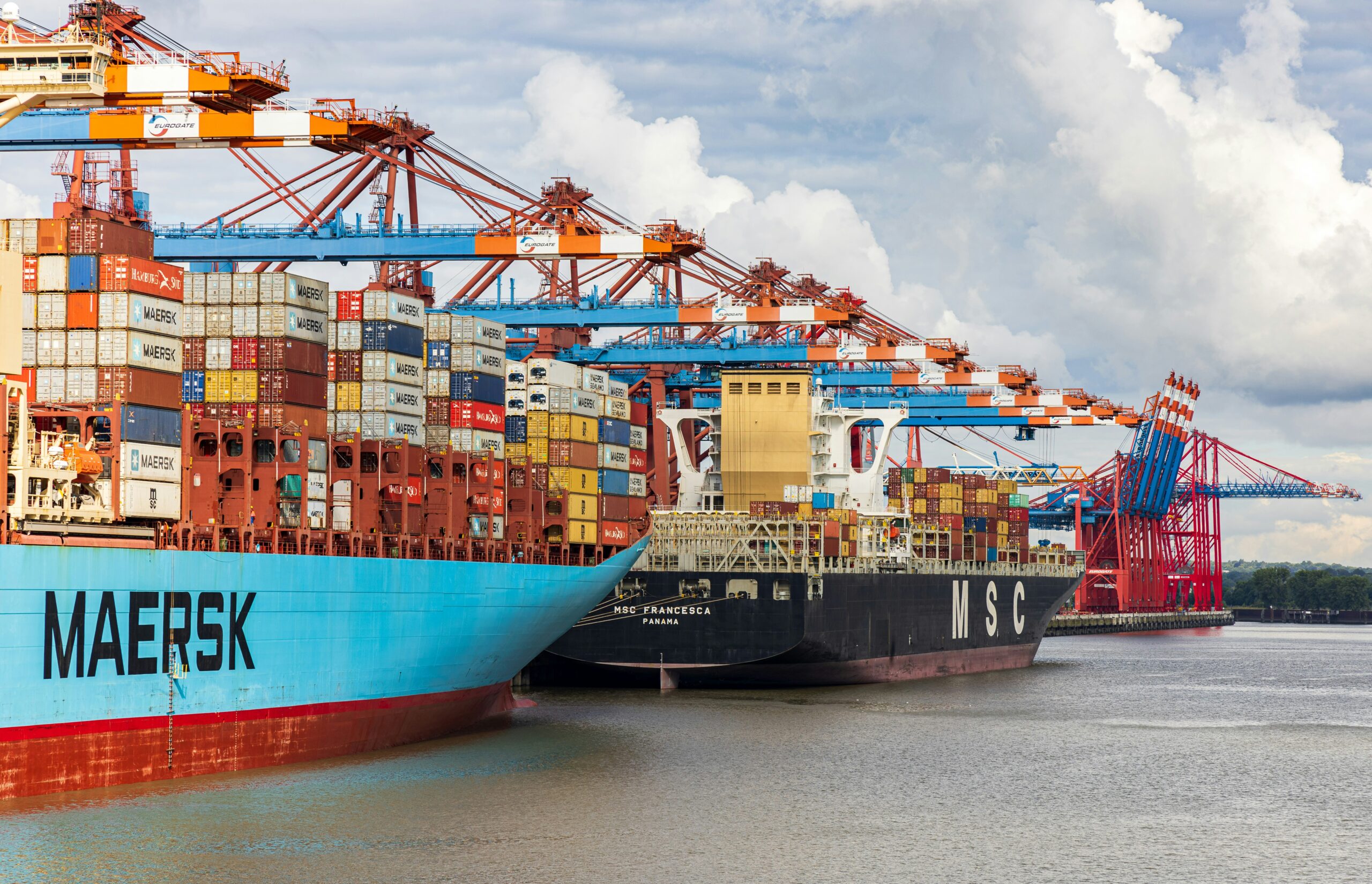 Port crane handling a shipping container